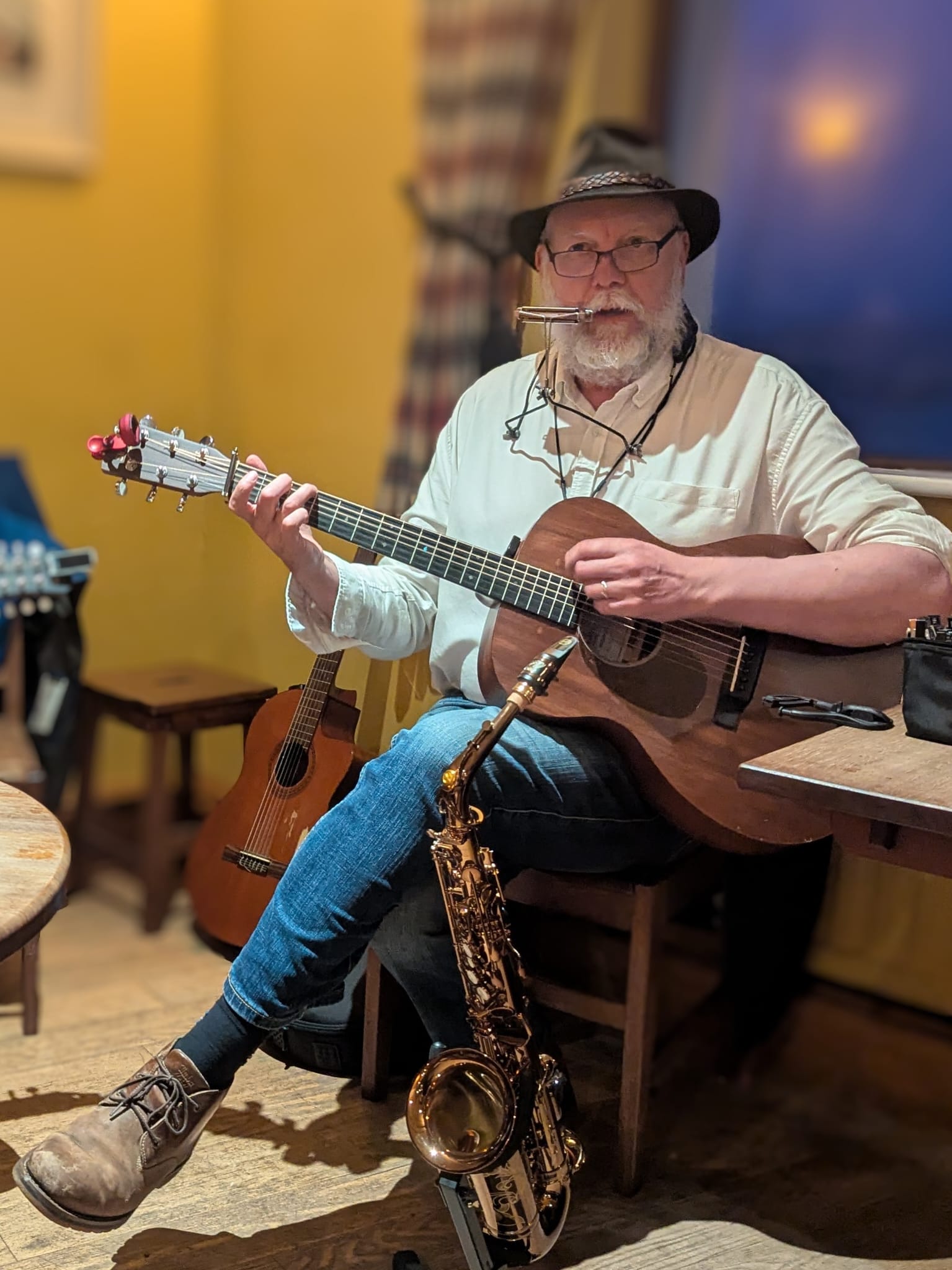 Sean McGrath playing guitar with saxophone and harmonica